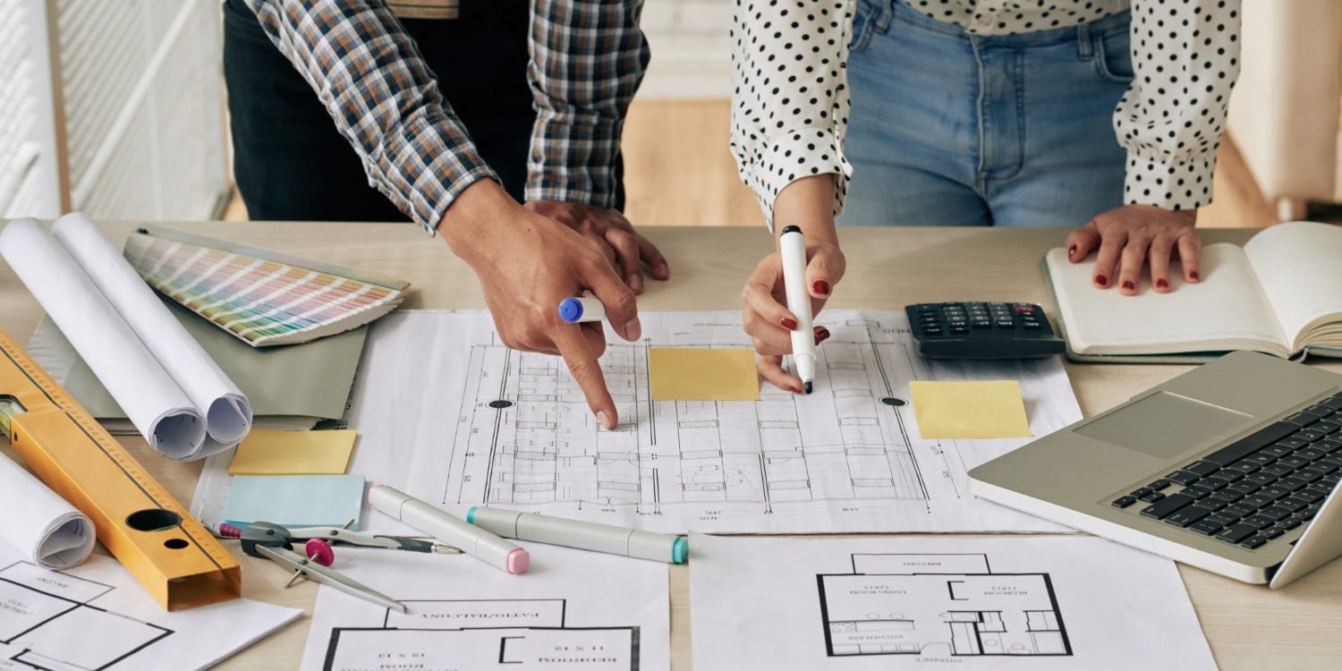 two people with house blueprint two people with house blueprint